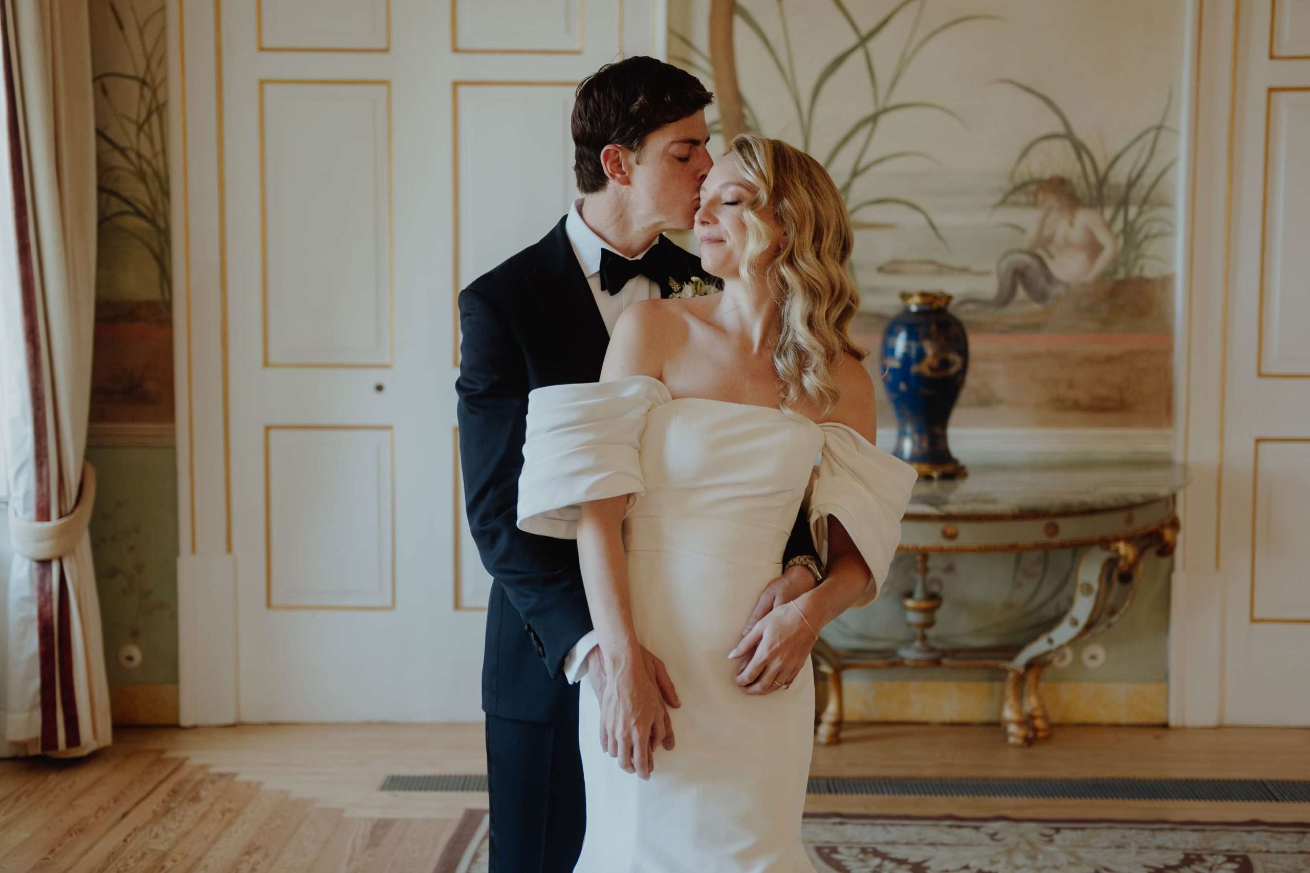 Bride and groom posing in ball toom of palace of seteais