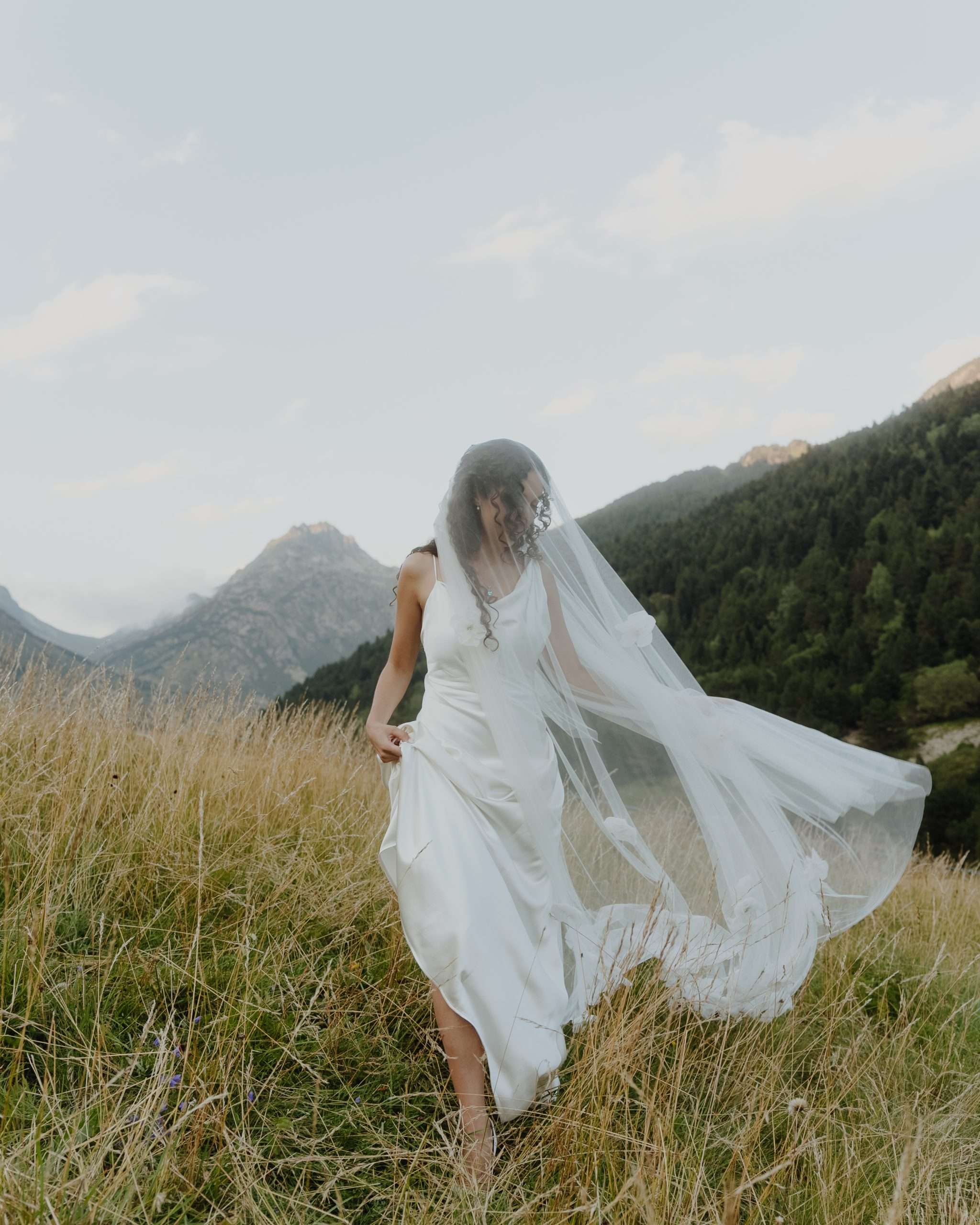 Bride walking on mountain at destination wedding Andorra