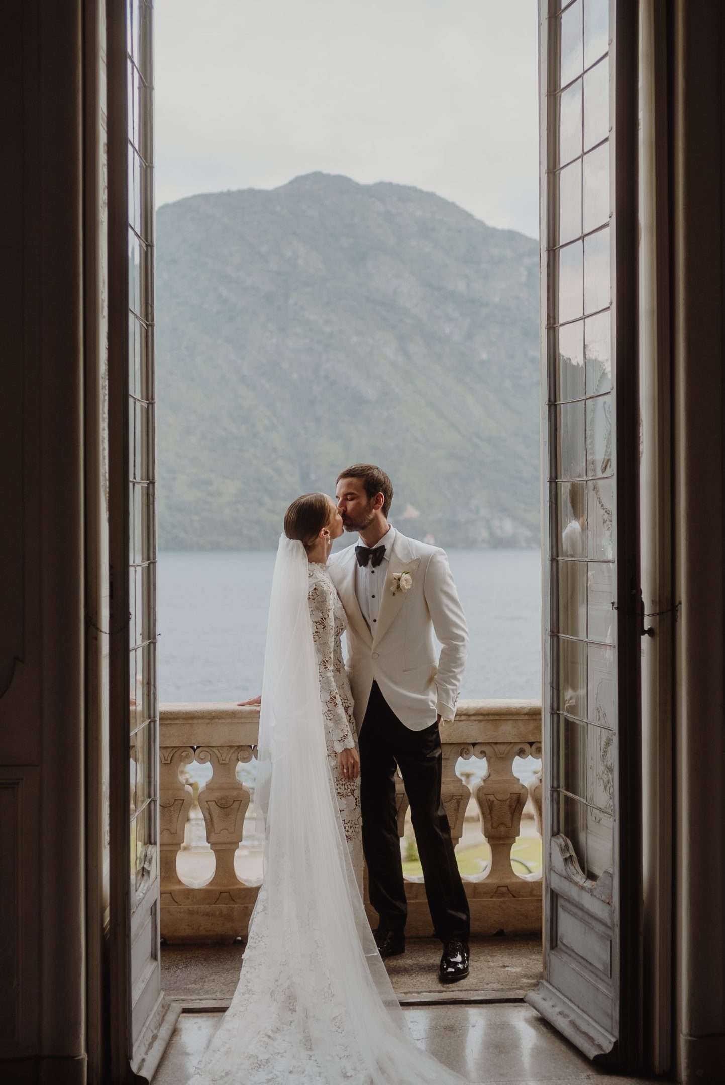 Bride and groom in Villa Sola balcony in Lake Como