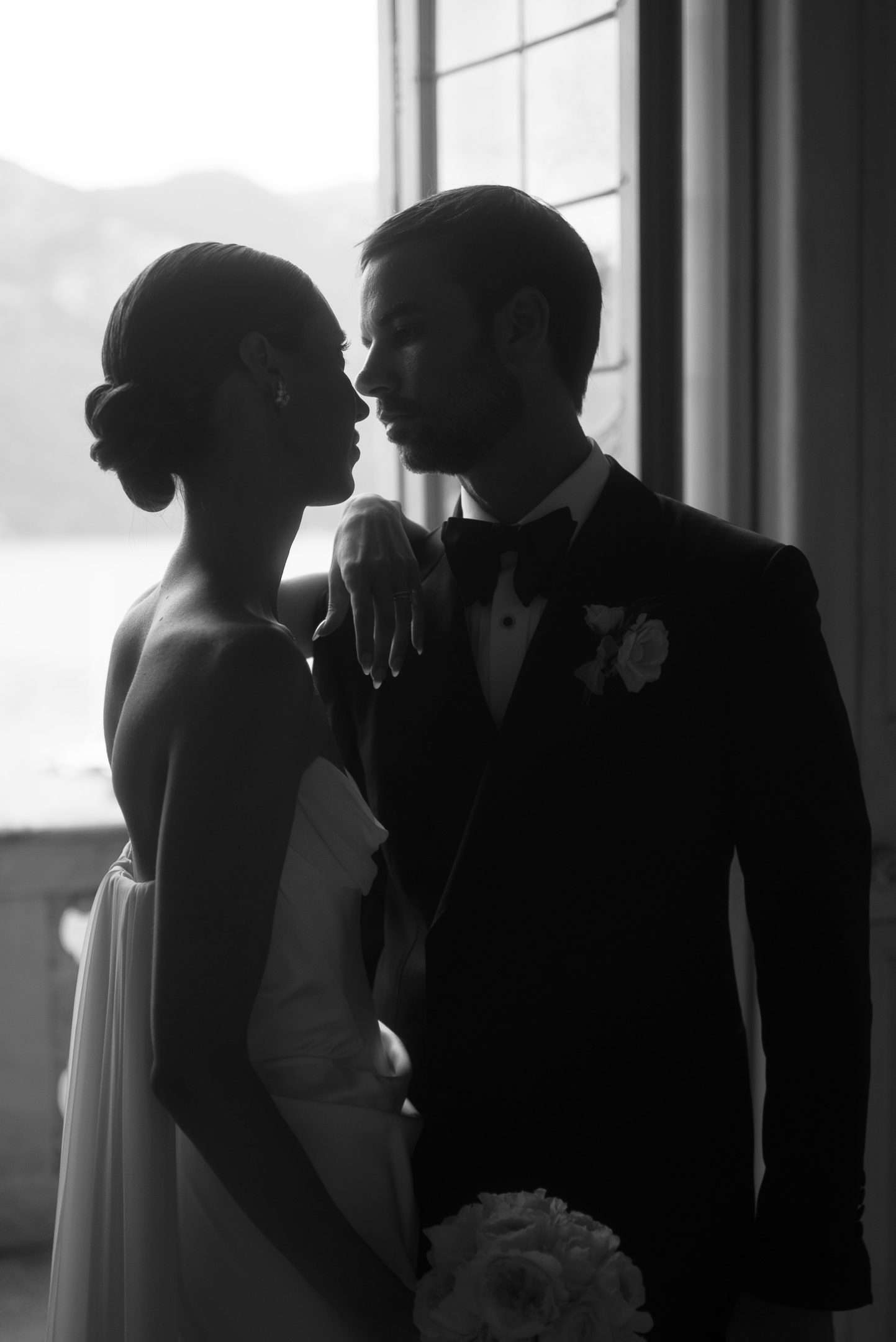 Bride and Groom posing in front of window in Villa Sola Cabiatti