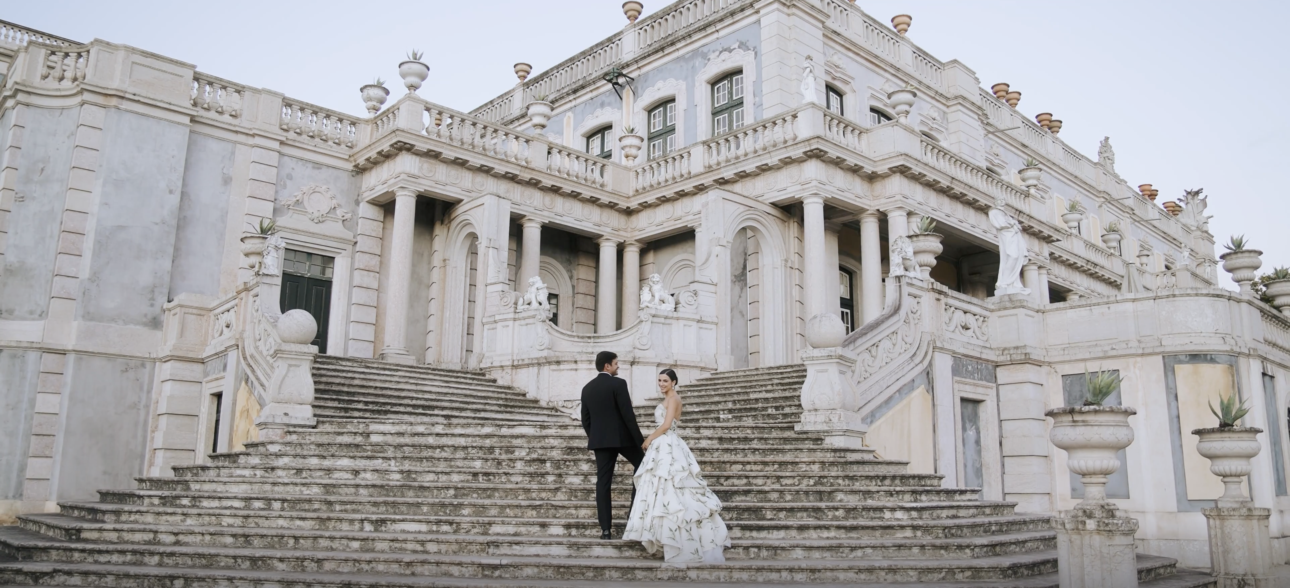Bride and groom walking up the stairs at Queluz Palace Lisbon